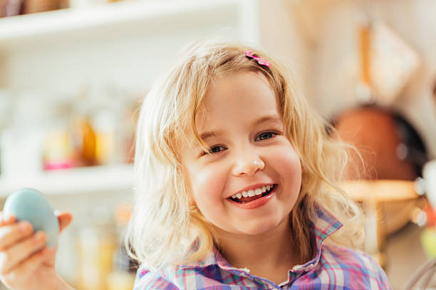 istock Little Girl Holding Natural Dyed Easter Egg 513892624