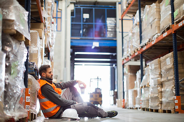 istock worker exhausted after a day's work resting in a warhouse. 513894806
