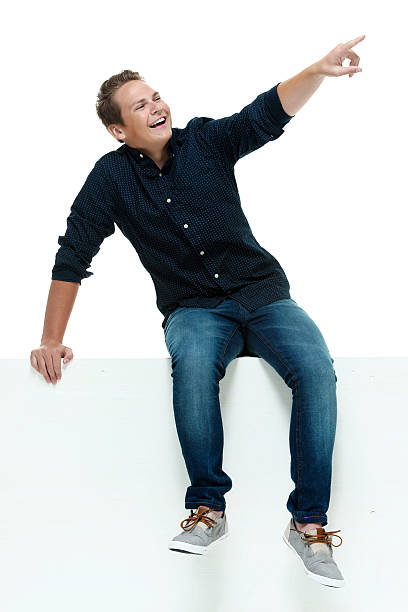 istock Cheerful male on box & pointing away 513901047