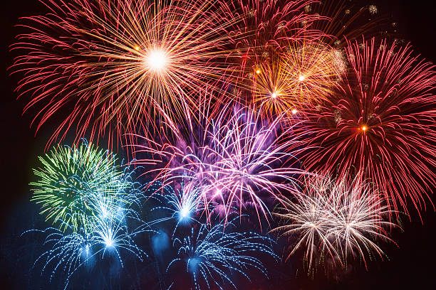colorful firework on night sky - vuurwerk stockfoto's en -beelden