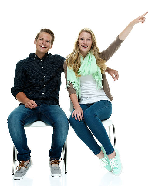 istock Cheerful couple on chair & pointing 513902401