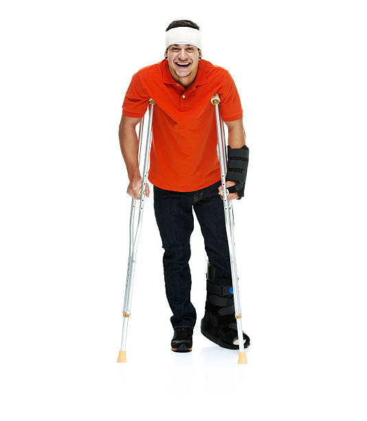 istock Smiling injured man standing with crutches 513902527