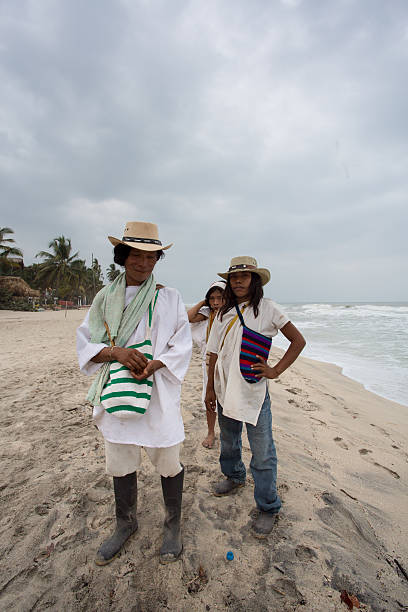 Palomino, Colombia - January 19, 2014: Group of unidentified Wayuu familly members posing in front of the camera on the Caribbean beach in Colombia 2014.