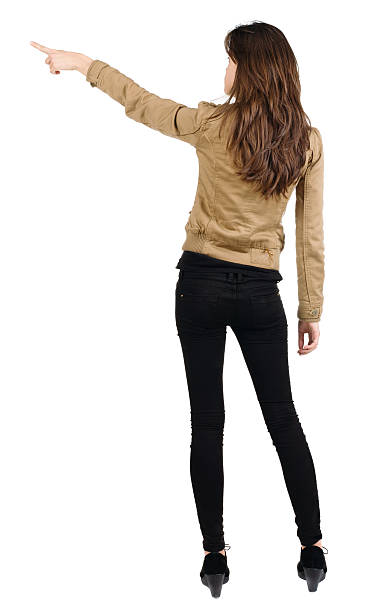 istock Back view of young brunette woman pointing 513903795