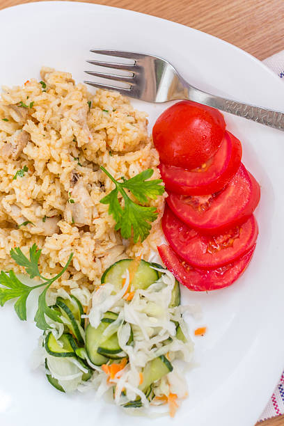 istock Delicious rice with pork meat and salad 513905047