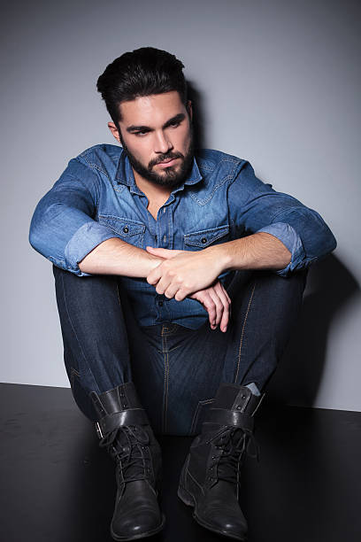 istock Man in blue shirt sitting 513906005