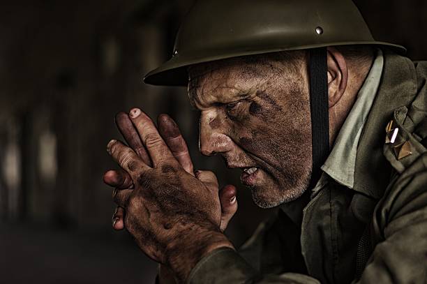 istock when duty calls,soldier with two hands together expressing suffering 513906175