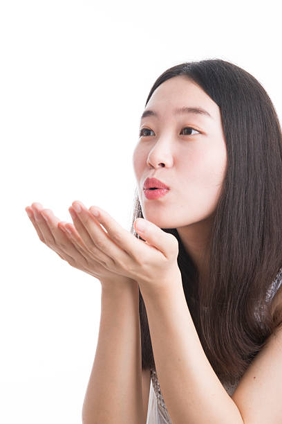 istock Woman blowing on her open hand 513906293