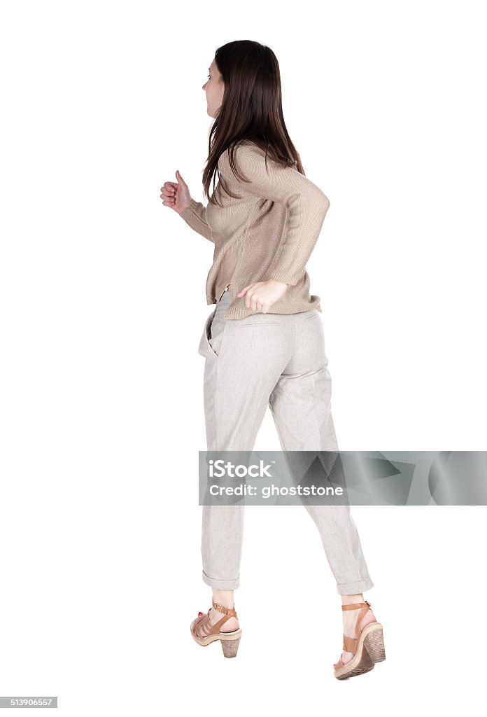 back view of running  woman. back view of running  woman. beautiful brunette girl in motion. backside view of person.  Rear view people collection. Isolated over white background. Activity Stock Photo
