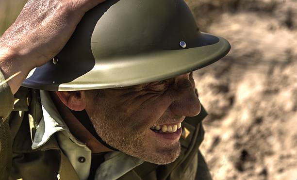 istock take cover, soldier holding his helmet in place 513907819