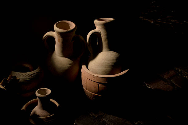 istock Jars / amphorae emerge from the shadows 513908331