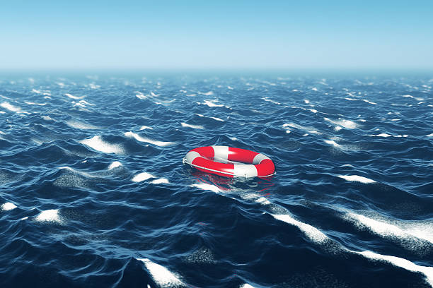 istock Lifebuoy floating in Deep Blue Sea 513917229