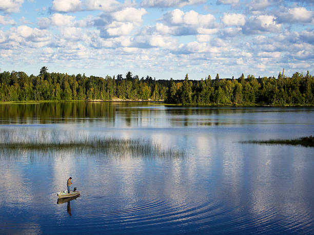 Lone fisherman on a northern lake near Timmins, Ontario, Canada