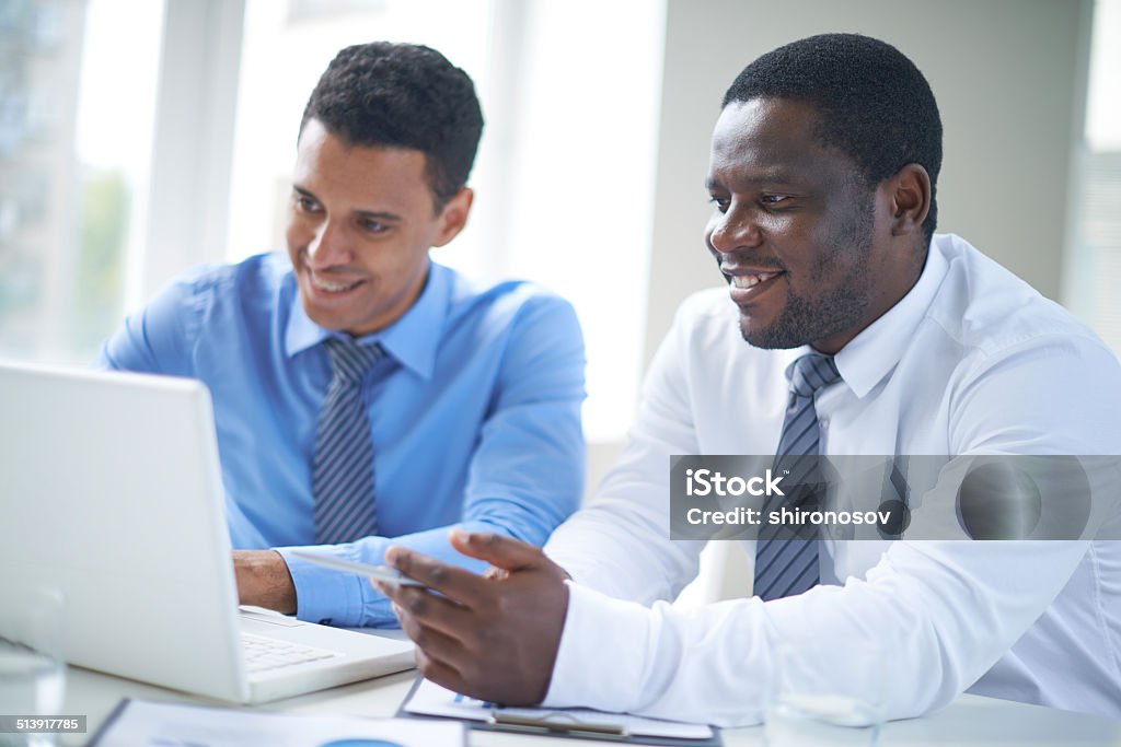 Presentation Businessman of African-american ethnicity pointing at laptop screen during presentation Adult Stock Photo