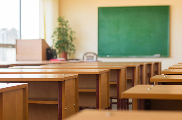 istock Classroom with desks and a green blackboard 513918379