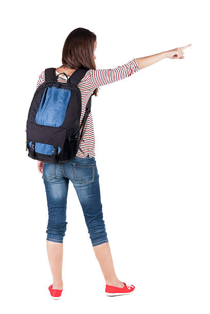 istock Back view of  pointing woman with backpack looking up. 513918691