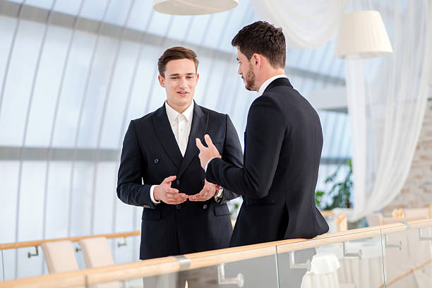 istock Two successful and confident businessman talking in an office 513918839