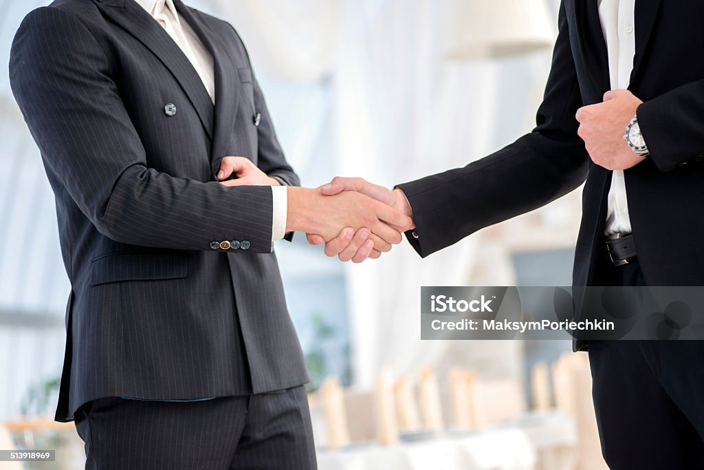 Transaction business. Two successful and confident businessman t Transaction business. Two successful and confident businessman talking in office shaking hands with each other Active Seniors Stock Photo