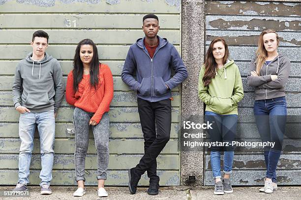 Gang Of Teenagers Hanging Out In Urban Environment Stock Photo - Download Image Now - Teenager, Adolescence, Sadness