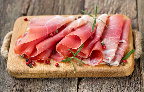 istock sliced prosciutto on a wooden board 513920447