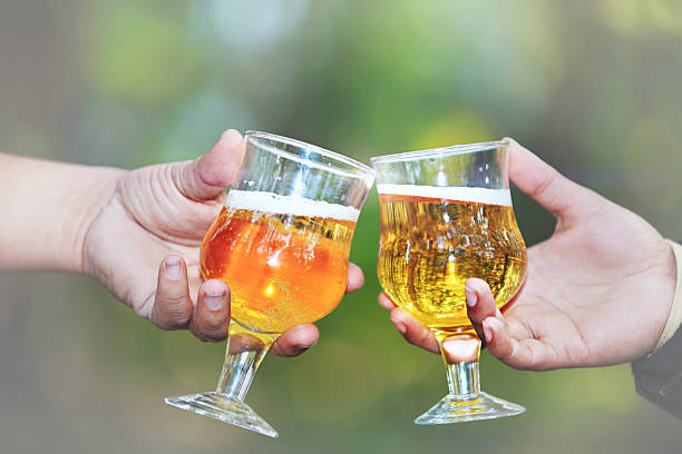 istock Two glasses of gold colored wine with nature background 513933020