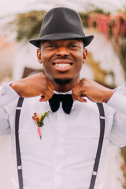 istock Happy african groom sincerely smiling and corrects his bowtie 513933422