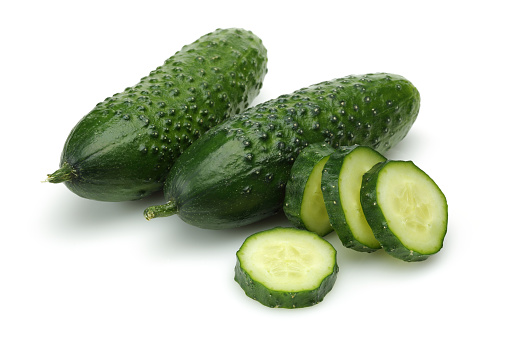 Fresh organic cucumbers on white