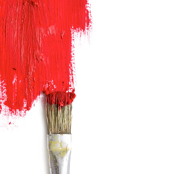 istock paint brush paints the white surface with red color, concept 513935524