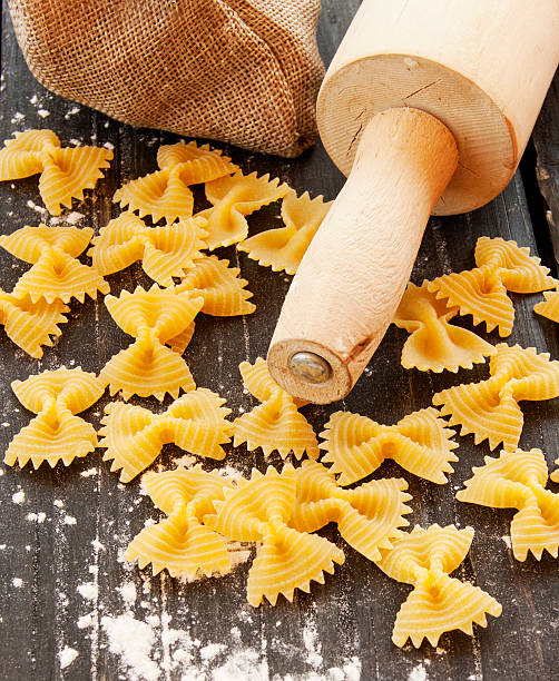 istock Uncooked pasta with flour on the table, selective focus 513935660
