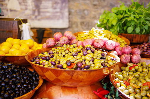Marinated garlic and olives on provencal street market in Provence, France. Selling and buying.