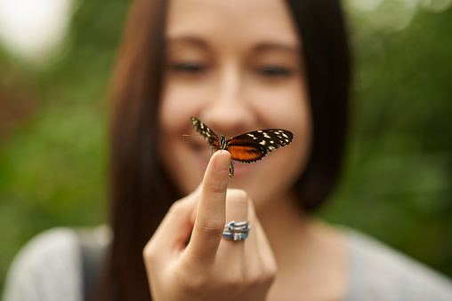 Cropped shot of a butterfly perched on a woman's fingerhttp://195.154.178.81/DATA/i_collage/pu/shoots/806439.jpg