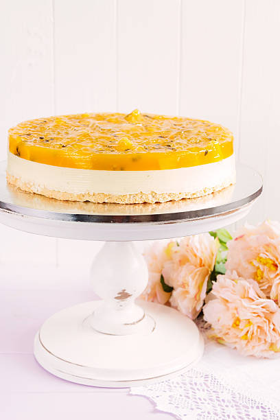 Fresh passion fruit cheesecake dessert Fresh fruit cake decorated with passionfruit and oranges mousse on light background. Modern european cake. Shallow focus deli pie stock pictures, royalty-free photos & images