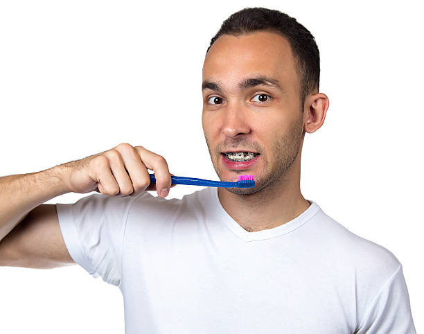 istock Smiling man, brackets and toothbrush 513938660