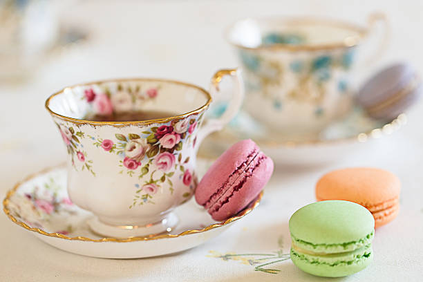 Cup of Tea with macaroons Two cups filled with tea and some macaroons afternoon tea photos stock pictures, royalty-free photos & images
