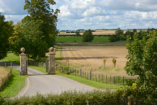 Swindon, England - September 18, 2015: Countryside and entrance gates to Avebury Manor in Avebury, Wiltshire, England