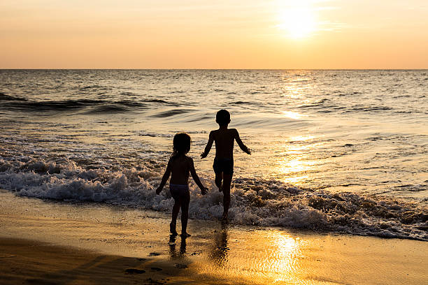 istock Kids playing on the beach. Exotic, tropical destinations. 513941396