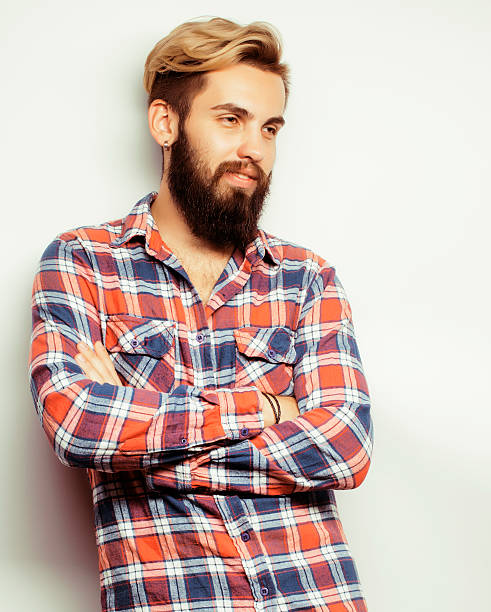 istock portrait of young bearded hipster guy smiling on white background 513941568