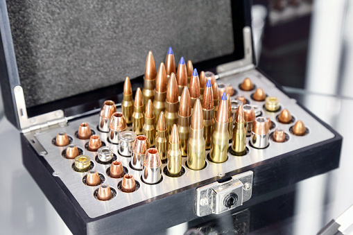 Rifle and pistol bullets of various calibers arranged in a box