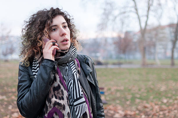 istock Young woman outdoors talking on mobile phone 513942762