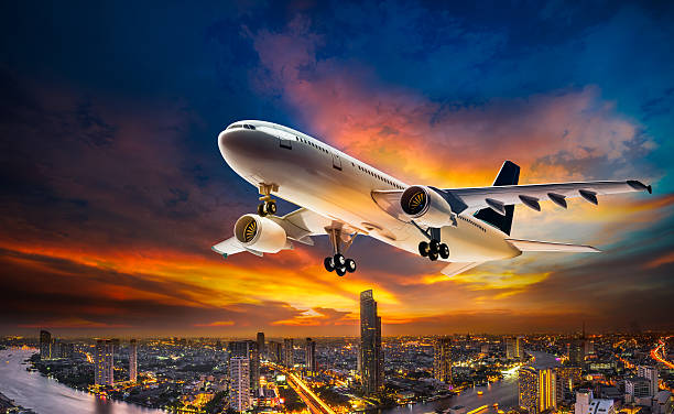 istock Airplane over night scene city 513942958