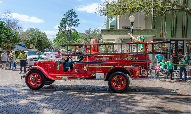 St Patrick's Day Parade, Winter Park, USA Winter park, USA - March 8th, 2015;  Old fire engine from Winter Park Fire Department taking part in the St Patrick Day street parade. winter park florida stock pictures, royalty-free photos & images