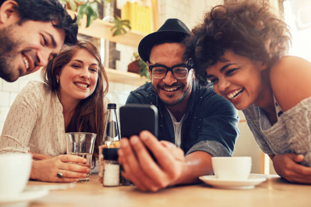 istock Friends watching photos on mobile phone 513943268