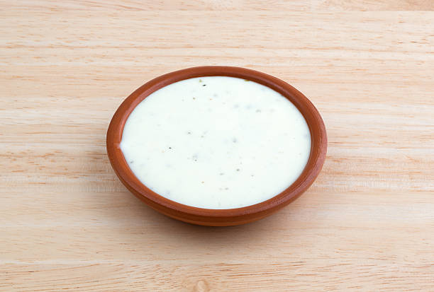 Bowl of ranch dressing on a wood table top