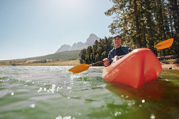 istock Senior man canoeing in a lake on a sunny day 513943886