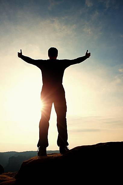 istock Gesture of triumph. Satisfy tall man on the peak. 513944106