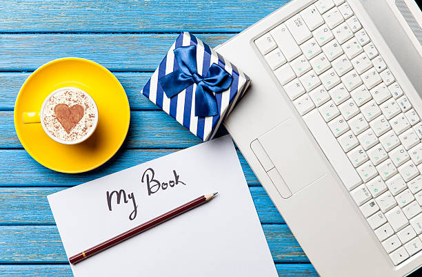 istock paper, gift, coffee and laptop lying on the table 513945008