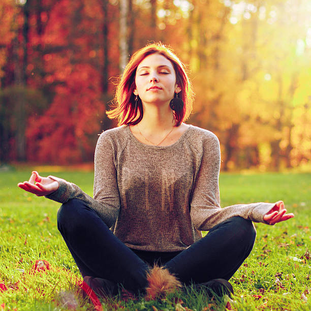 istock Young female meditate in park 513945834