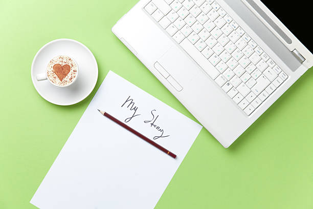 istock paper, coffee and laptop lying on the table 513946356