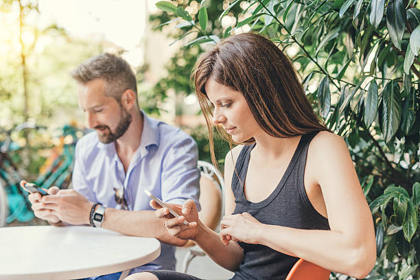 istock Young couple texting and surfing the net 513946392