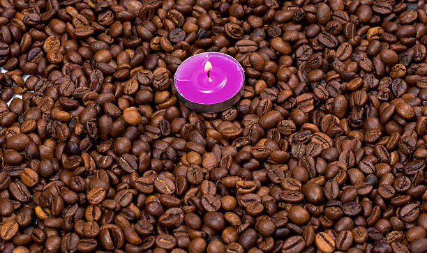 istock the scattered coffee grains and on them a pink candle 513946604